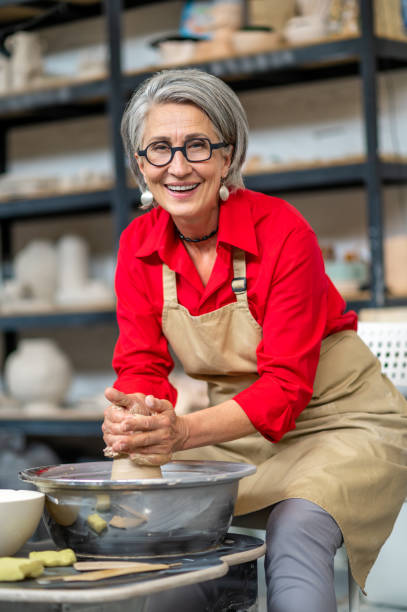 istock Woman working on potters wheel creating clay products at her workshop. 1534018204