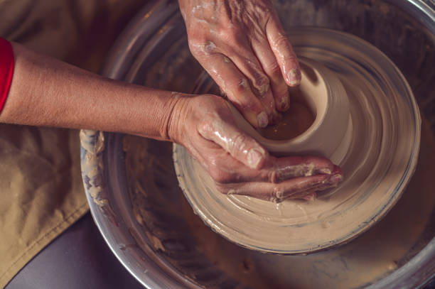 istock Ceramic bowl on a potter's wheel, ceramist's hands. 1534019824