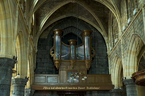 Old chair and modern organ in front of a old tombstone in Sankt Olai Kirke – Saint Olaf’s Church – is a Danish cathedral church in Helsingør also known as Elsinore in English. It has a history going back to around 1200, but the preset building is from 1559.