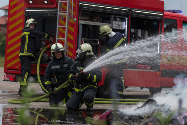 istock Firefighters fight the fire flame to control fire not to spreading out. Firefighter industrial and public safety concept. Traffic or car accident rescue and help action. 1534030565