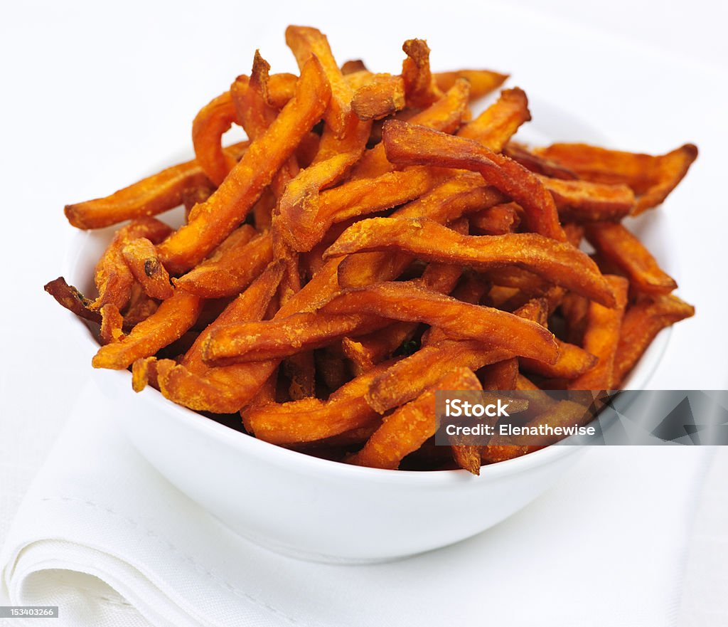 White bowl of thin sweet potato fries isolated on white Closeup of sweet potato or yam fries in white bowl French Fries Stock Photo
