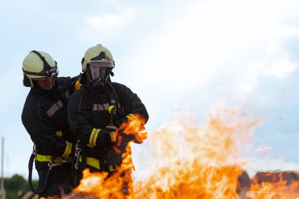 istock Firefighters fight the fire flame to control fire not to spreading out. Firefighter industrial and public safety concept. Traffic or car accident rescue and help action. 1534037285