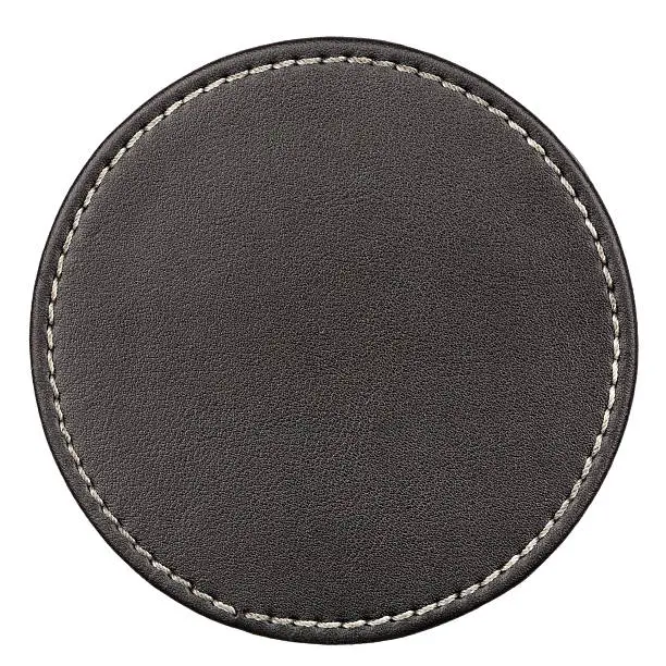 Round black leather table coaster isolated on white