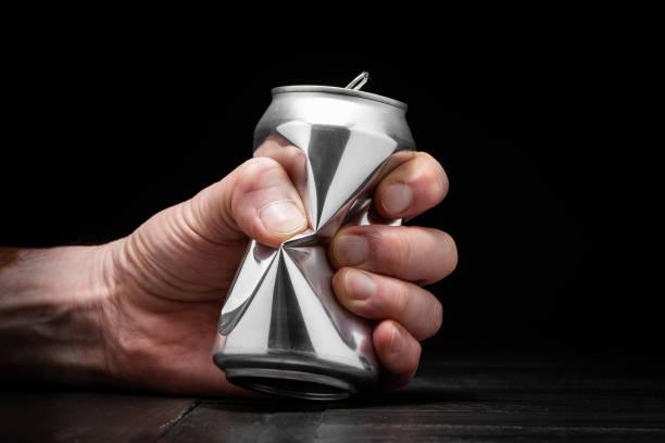 Hand crushing an aluminium can