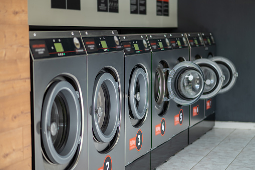 Industrial laundry machines in a public laundromat, self service laundry