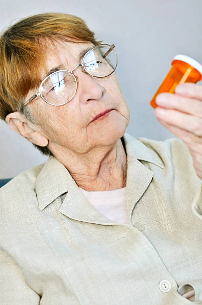 istock Elderly woman with pill bottle 153408718