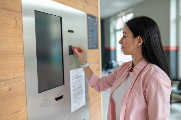 istock Woman buying coffee from automatic vending machine. 1534089539