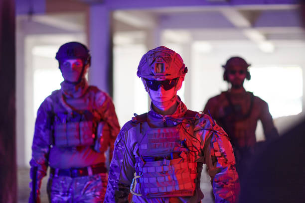 istock Soldier squad team walking in urban environment colored lightis 1534090641