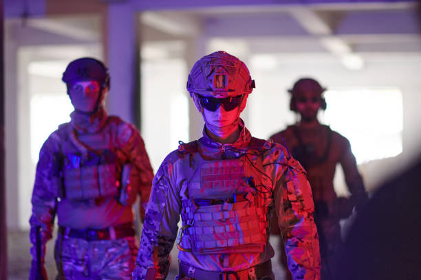 istock Soldier squad team walking in urban environment colored lightis 1534093860