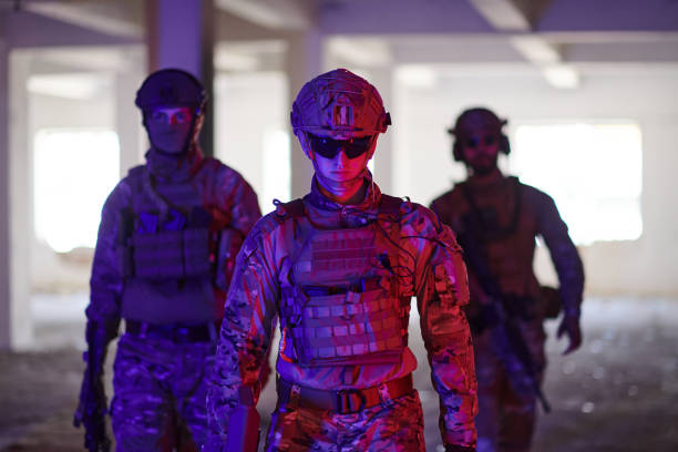 istock Soldier squad team walking in urban environment colored lightis 1534095405