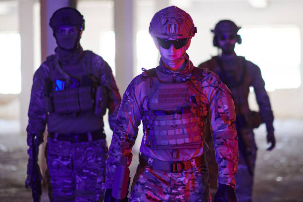 istock Soldier squad team walking in urban environment colored lightis 1534098096