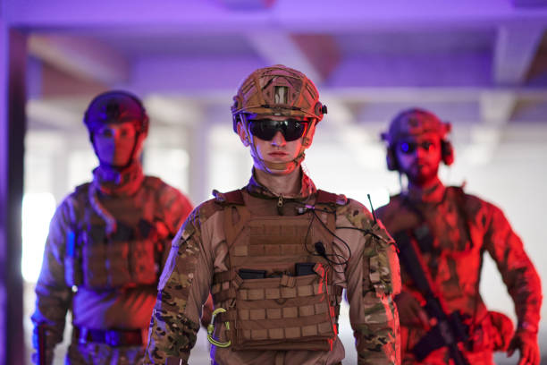 istock Soldier squad team walking in urban environment colored lightis 1534105119