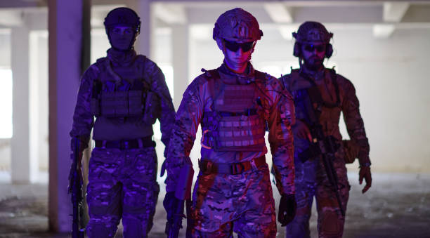 istock Soldier squad team walking in urban environment colored lightis 1534113548