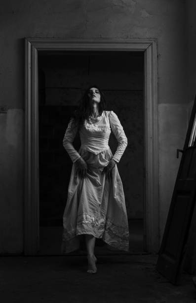 das spukhaus - women ghost walking old fashioned stock-fotos und bilder