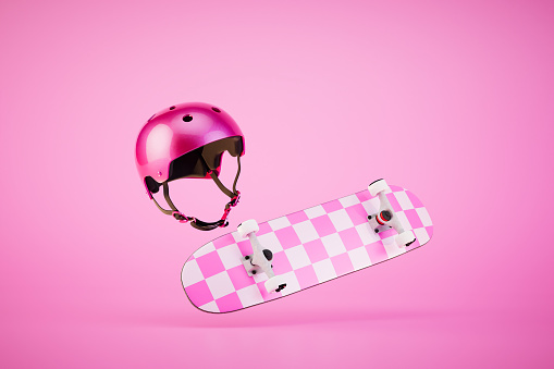 The concept of extreme sports. A pink skateboard and protective helmet on a pink background. 3D render.