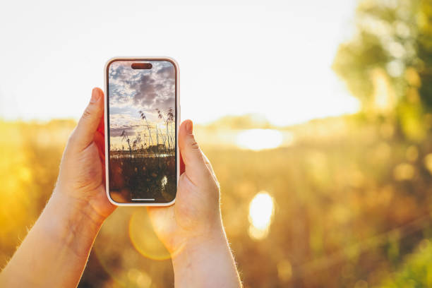 istock Girl photographing a beautiful sunset 1534215865