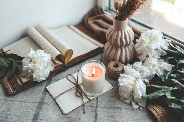 istock Burning candle and white peonies, vintage aesthetic 1534222786