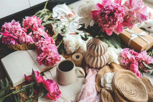 istock Beautiful spring composition, good morning concept. Cup of tea, peonies and open book 1534223847
