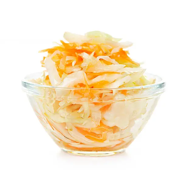Coleslaw in glass bowl on white background