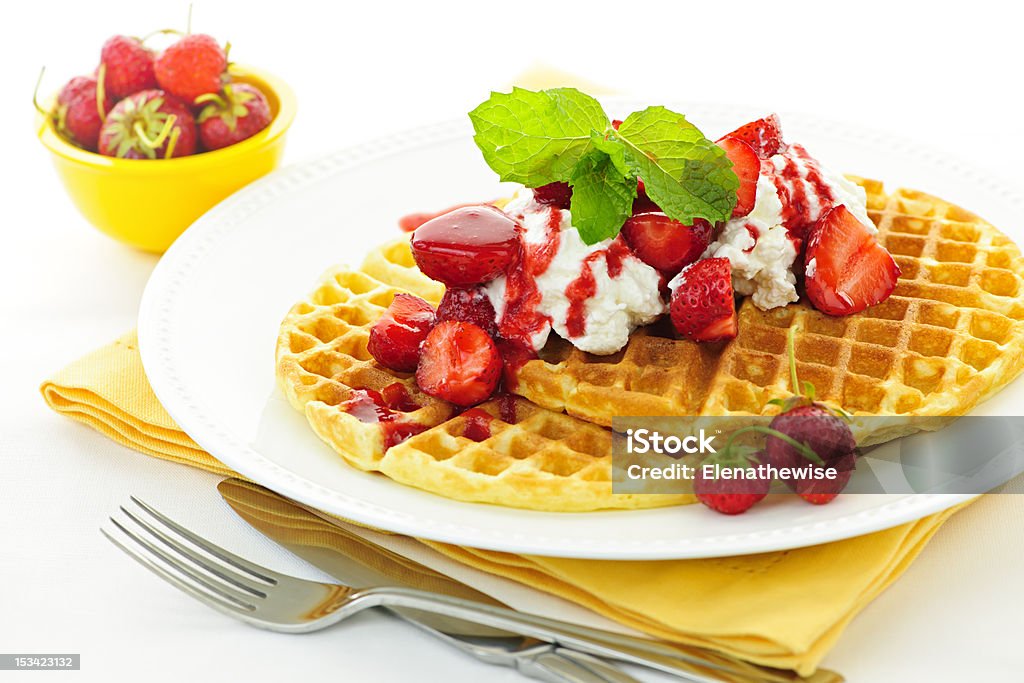 Belgian waffles Plate of belgian waffles with fresh strawberries and whipped cream Belgian Culture Stock Photo