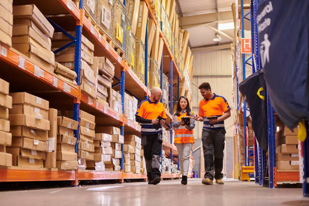 female warehouse supervisor with colleagues