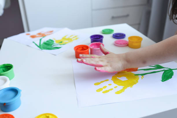 istock Children's art workshop, the child makes a handprint with paints 1534262810