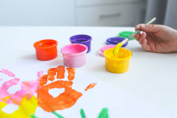 istock Children's drawing from an imprint of hands with paints 1534263236
