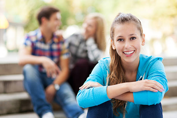 istock Smiling woman with friends in background 153428784