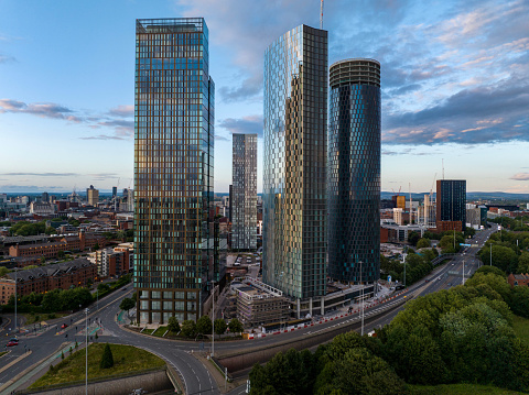 An aerial photograph of Deansgate in Manchester, England. The image was produced at twilight and shows the urban skyline of downtown Manchester