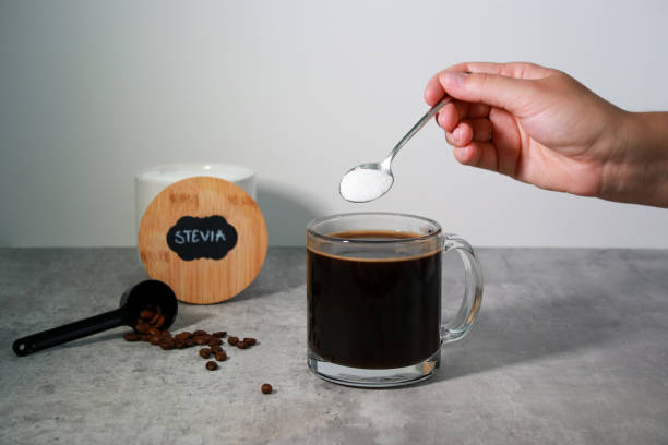 istock Woman's hand put stevia sweetener in a black coffee 1534320566