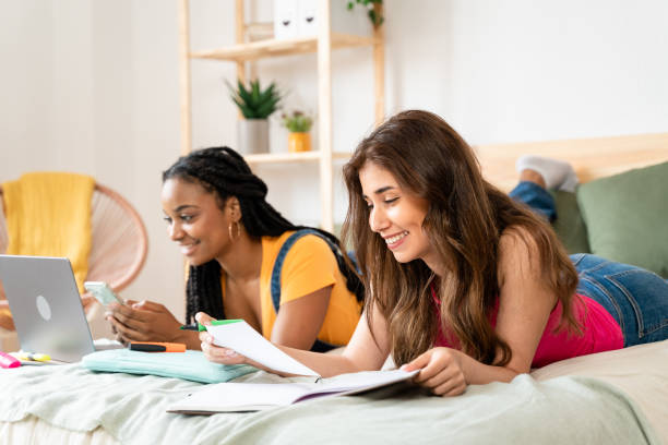 istock Brunette woman lying in bed reading notes in her notebook. 1534323764