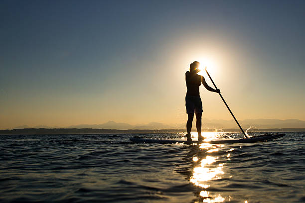 istock Woman paddling stand up paddle board 153432761