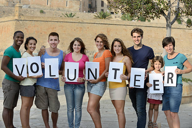 istock Happy diverse group holding volunteer sign 153432856