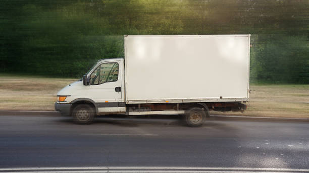 kleiner lastwagen mit leerer weißer seite zum attrappen auf der autobahn - van white truck mini van stock-fotos und bilder