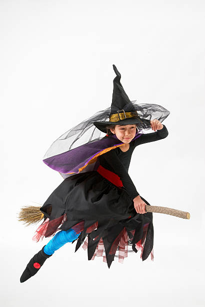 istock halloween, Pretty smiling girl dressed as witch 153435243