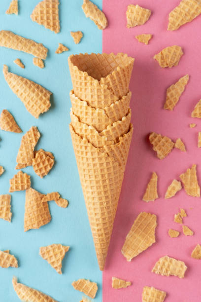 istock Ice cream waffle cones on pink and blue background 1534355970