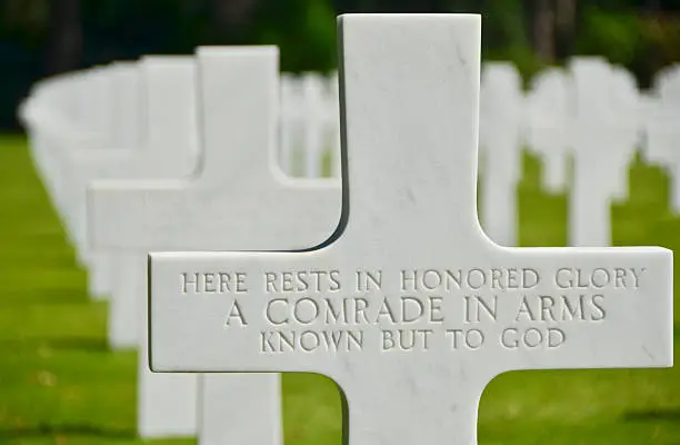 A tribute to an unknown soldier at the American cemetery in Normandy France.  The cemetery is overlooking the cliffs of the famous Omaha Beach and the English Channel.