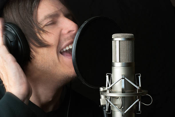 istock Man Records Vocals In Studio 153439524
