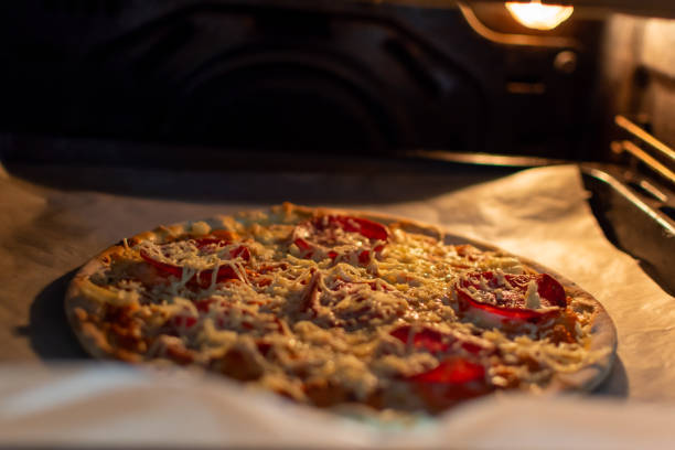istock Pizza with sausage and cheese in the oven 1534395892