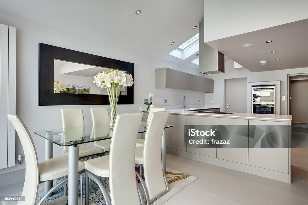 Modern kitchen and breakfast room Chic modern kitchen and breakfast room interior with stainless steel appliances.  Includes reflection in mirror of image by same contributor IS 10000403 Domestic Room Stock Photo