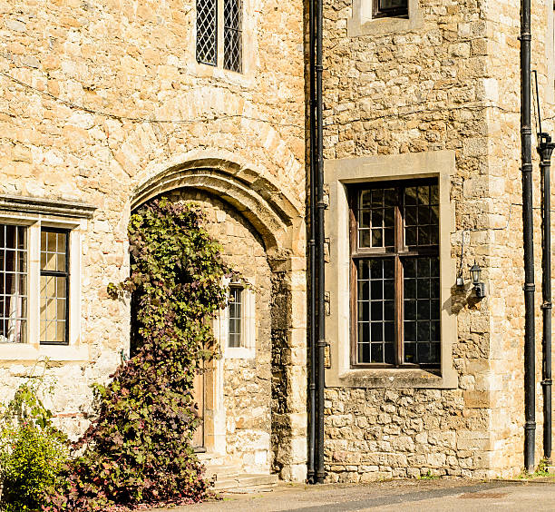istock Arched door and leaded windows set in stone. 153440691