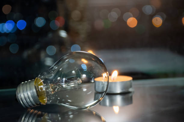 istock Incandescent lamp and candle on the table 1534409104
