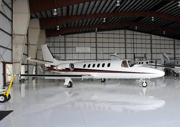 Luxury private jet in hangar between flights