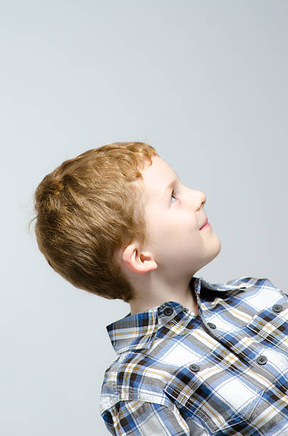 istock Redheaded boy looking up into the air 153446724