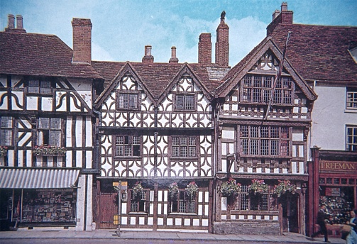 Stratford-upon-Avon, Warwickshire, England, UK, 1978. Old half timbered house facade in Stratford. Also: The Garrick Inn Restaurant & Pub and passers-by.