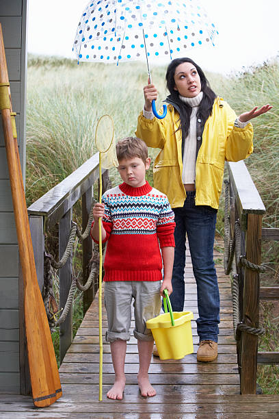 istock Sad woman and child with umbrella 153449174