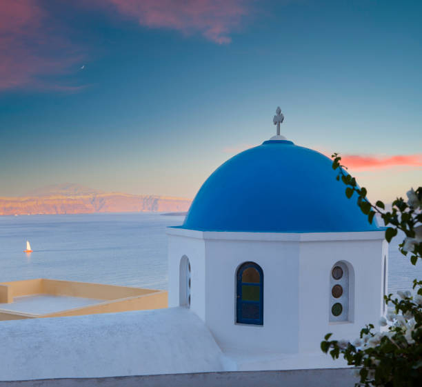 Greek church architecture Classical Greek church architecture. Sunset view of the white church with blue domes. Important travel destinations in Greece. Santorini island. greek orthodox stock pictures, royalty-free photos & images