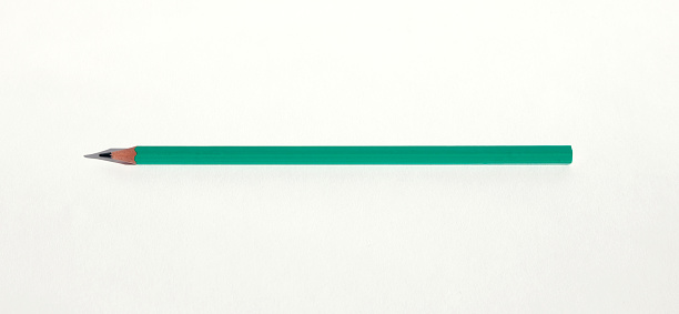 Green pencil on white background - macro