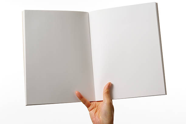 istock Holding an opened blank magazine against white background 153451308