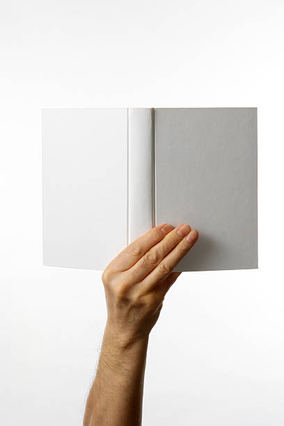 istock Holding an opened blank book against white background 153451359